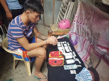 Drug suspect Carl James dela Cerna, 20, is shown with the half a kilo of shabu valued at P3.4 million caught in his possession in a drug bust in Barangay Labagon, Cebu City on Sunday, March 17, 2019. |CDND Photo/Benjie Talisic