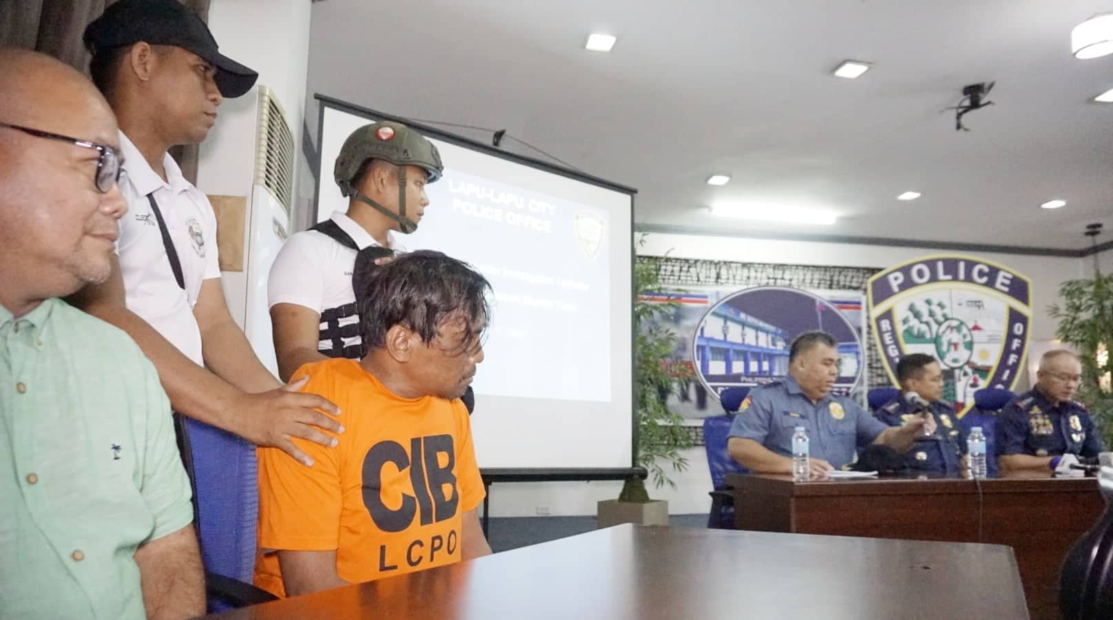 Renato Bayuban Llenes listens as top police officials hold a press conference at the Camp Sergio Osmeña-PRO-7 headquarters. 