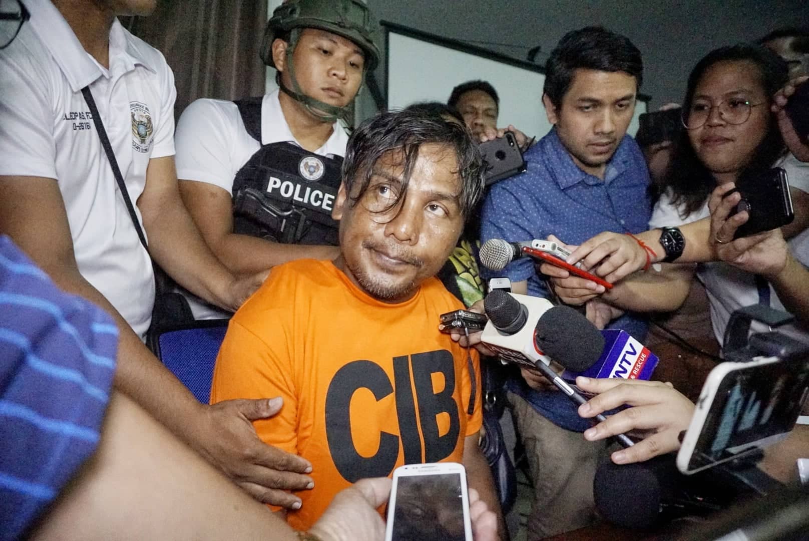Renato Bayuban Llenes, the self-confessed suspect in the murder of Christine Lee Silawan, is presented to the media at the Camp Sergio Osmeña