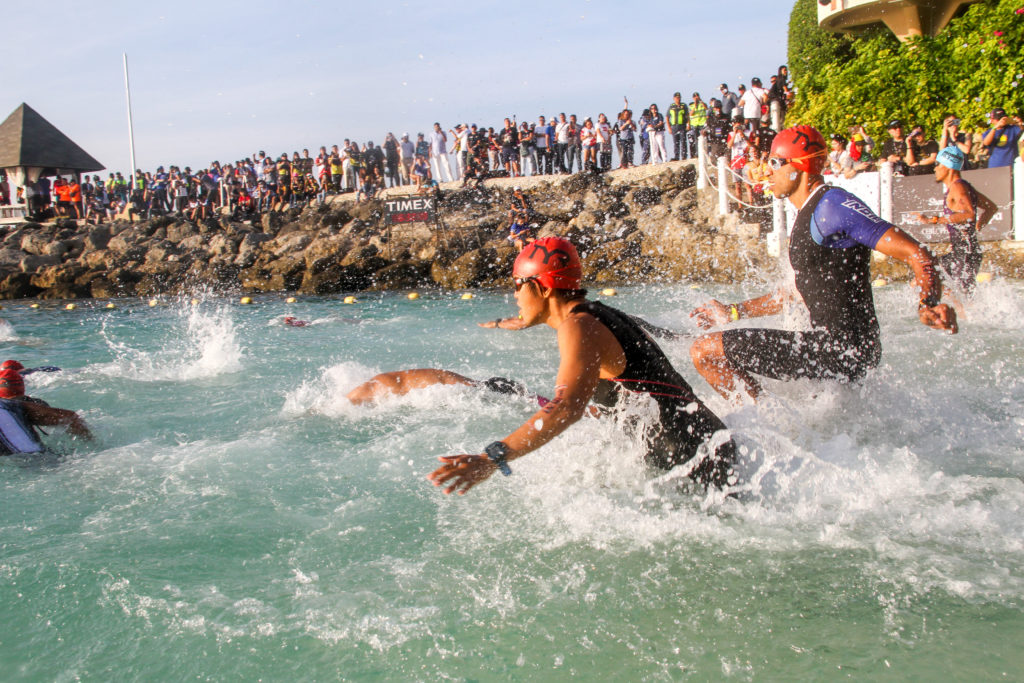 IRONMAN 70.3 moved again to another date due to health and safety concerns brought about by COVID-19. In photo are Triathletes dive into the water for the swim leg of the Ironman triathlon event in Cebu in this August 2019 photo. | CDN Digital file photo