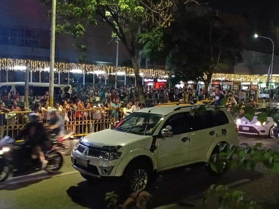 Onlookers mill on the street around the Mitsubishi Montero Sports SUV of Jeffrey Gomotin, 49, a businessman, who was shot dead past 9 p.m. on Sunday, Sept. 22, 2019, by motorcycle-riding men while the SUV had stopped on a read light along Juan Luna Avenue Extension, Barangay Mabolo, Cebu City.