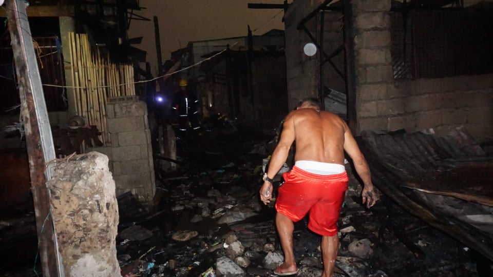 A resident walking at the Barangay Duljo-Fatima, Cebu City fire site on February 28, 2020.