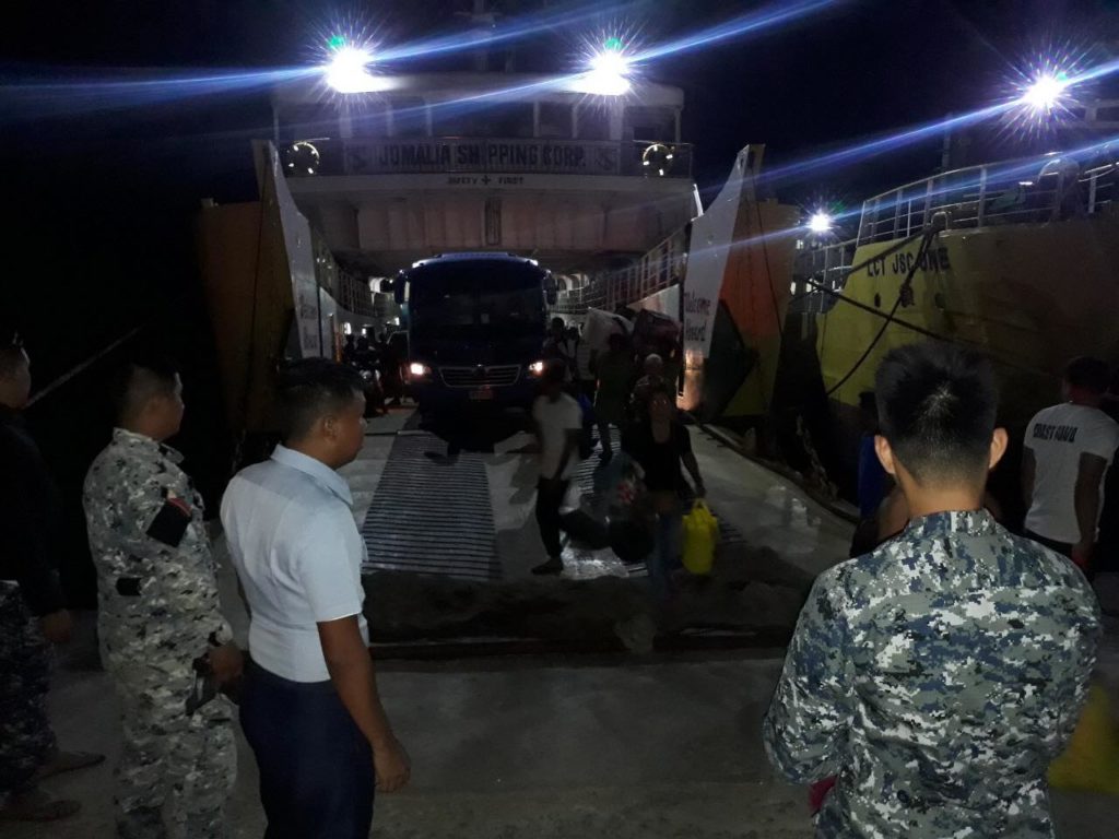 Vehicles drive off the MV Mika Mari III, a ro-ro, after the troubled vessel which was towed from the Camotes Sea due to its engine malfunctioning, arrive at the Consuelo port at past 6 p.m. of March 2, 2020. | PCG-7 photo