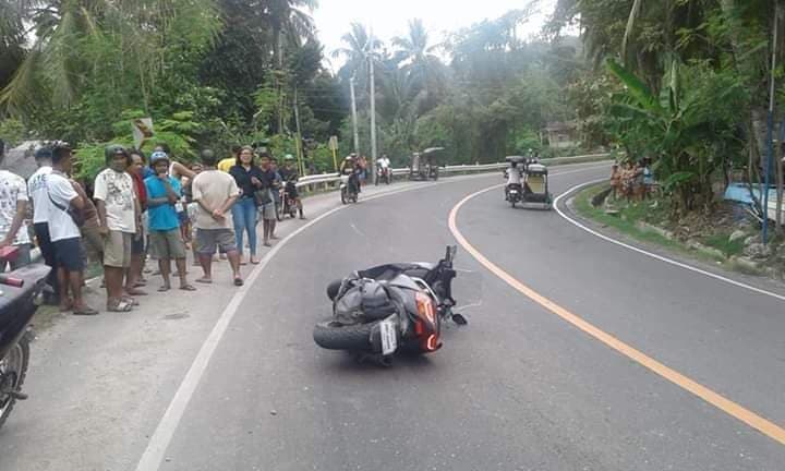 The motorcycle of teacher Mark Ocampo lies in the middle of the highway in Barangay Balud, Dalaguete town in southern Cebu after it crashed into a road railing. Ocampo died in the crash. | Contributed photo