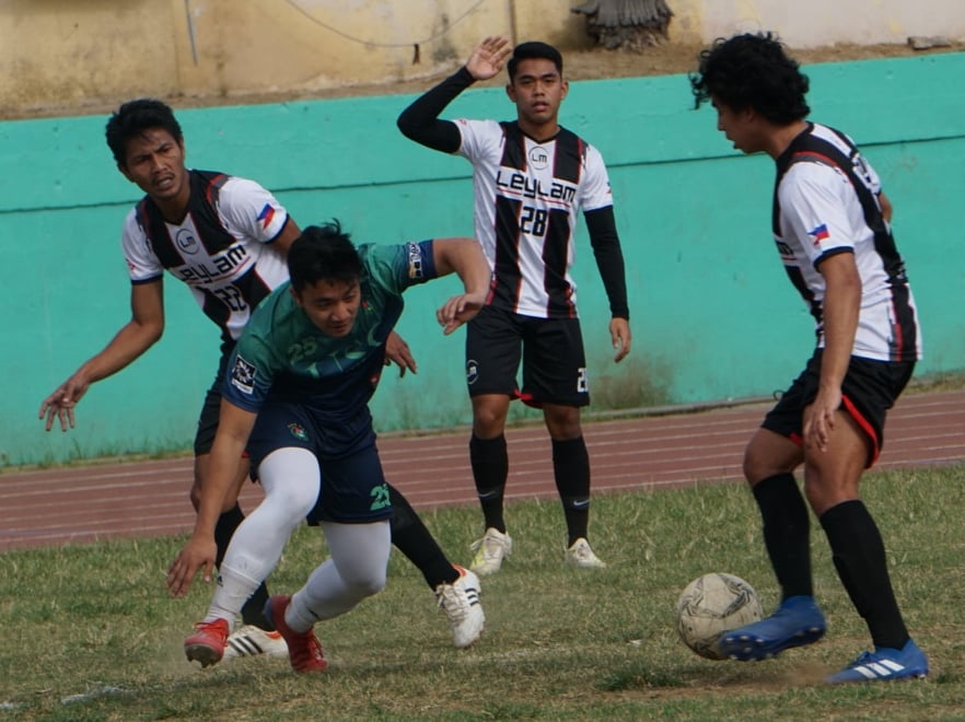 A Leylam FC booter (in white uniform) dribbles past a University of San Carlos defender during their Aboitizland Football Cup match on February 2, 2020. Leylam will battle Don Sacredale on Sunday, March 8, 2020 at the JH football field in Canduman, Mandaue City. | Gerard Francisco