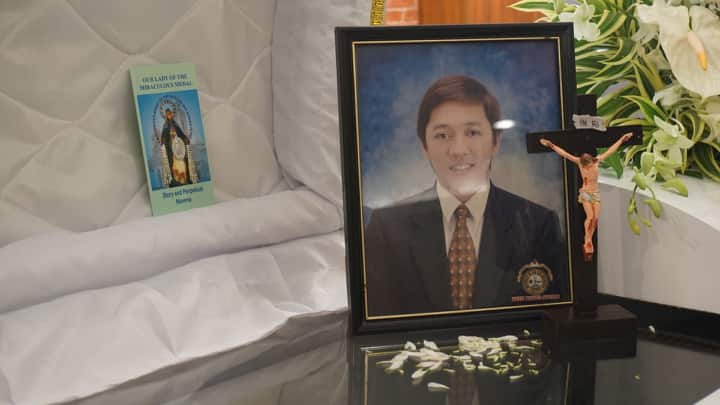 A photo of the late Marc Ladaran is placed atop his coffin. | Gerard Francisco