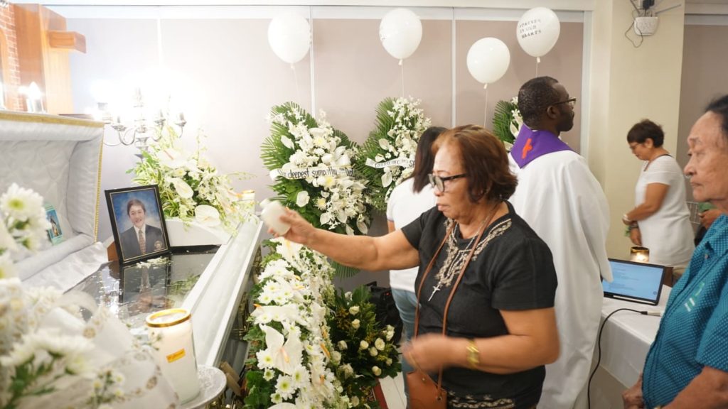 Relatives sprinkle holy water on the coffin of the late Marc "Makie" Ladaran during his Mass Service on March 7, 2020 at his wake at the Columbario de la Sagrada at Imus Road in Cebu City. | Gerard Francisco