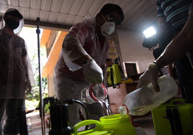 Cagayan de Oro health teams prepare a disinfectant solution that will be used on Saturday, March 14, 2020. Officials here have ordered a city-wide disinfection in all places of prayers following the death of patient no. 40, the first confirmed COVID-19 case in Mindanao. Photo by Froilan Gallardo