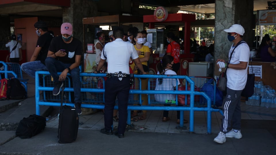 Passengers heading home to northern Cebu towns and cities wait for their bus rides home at the Cebu North Bus Terminal in Barangay Subangdaku, Mandaue City on March 27, 2020. | Gerard Francisco