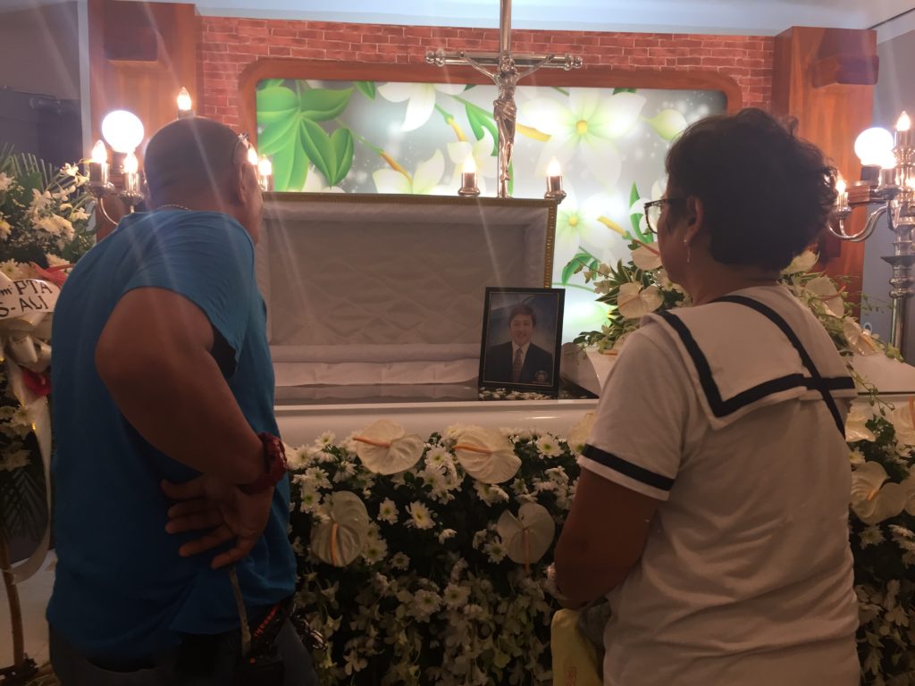 The parents of Marc Ladaran, who died in a motorcycle crash in Dalaguete town on March 5, 2020, grieve as they watch their son inside a coffin at a funeral parlor in Cebu City. | Delta Letigio