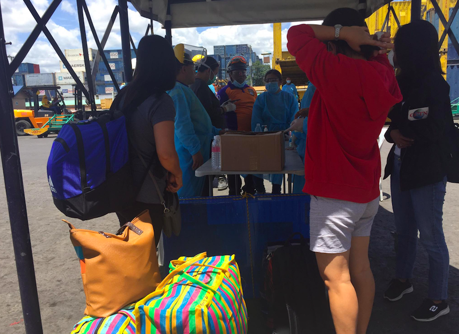 Passengers undergo checks including having their temperatures taken after disembarking from a ship that arrived from Manila at the Cebu City port on Saturday morning, March 14, 2020. One of the passengers was quarantined and considered a PUI.| Delta Letigio