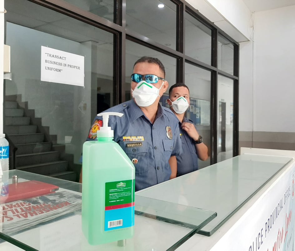 Bottles of alcohol, hand sanitizers and personnel wearing face masks greet visitors upon entering the Cebu Provincial Police Office headquarters. /CDND photo Morexette Marie B. Erram