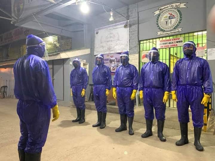 Personnel of the Mandaue City Jail are required to wear personal protective equipment (PPEs) before they are allowed to come in close contact with Persons Deprived of Liberty who now occupy the facility in Barangay Looc, Mandaue City. | Norman Mendoza