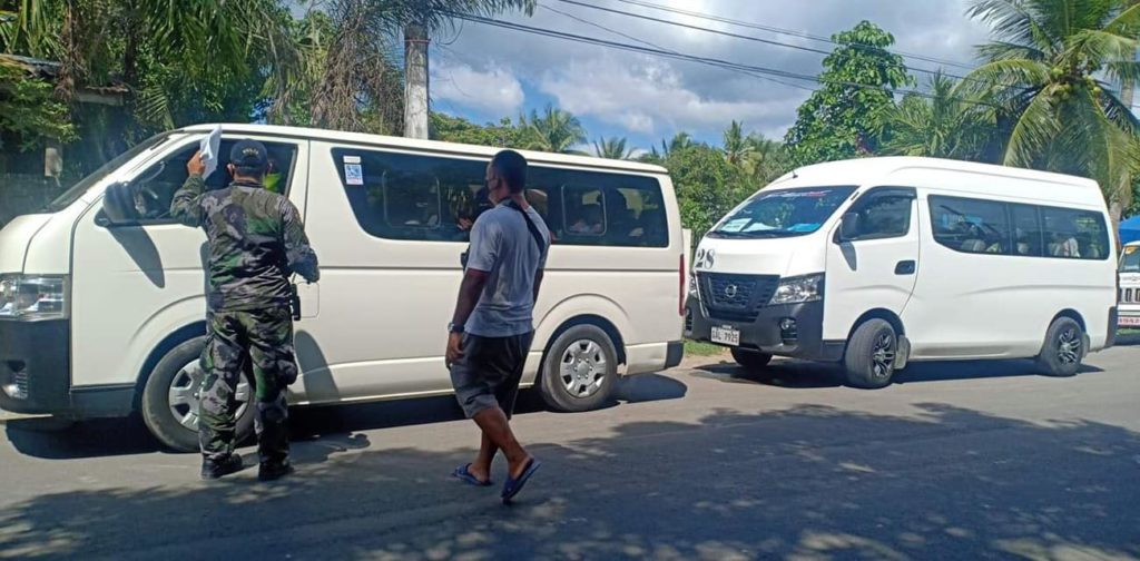 Two vans from MEPZ company are held at a checkpoint in Asturias, Cebu this Sunday afternoon, May 17, 2020, after they proceeded to enter the town without submitting to disinfection.| Photo from Asturias Police