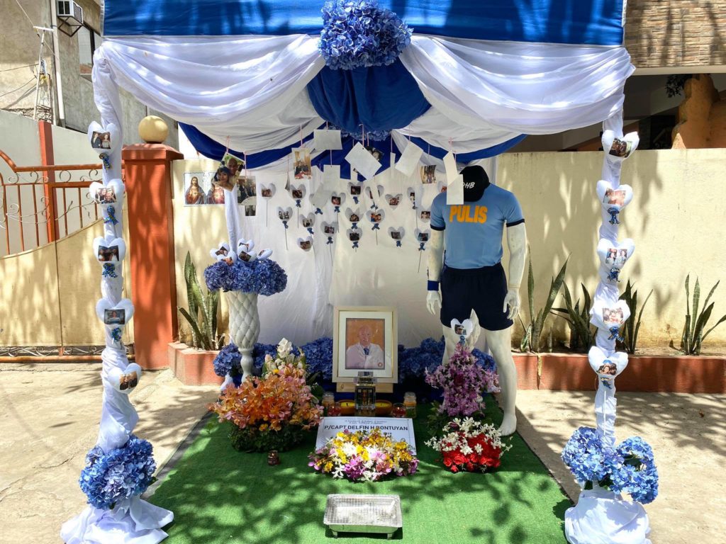 A replica of the grave of Police Captain Delfin Bontuyan, was setup outside their residence so their families and friends could offer some flowers and prayers. | Photo Courtesy of Christine Bontuyan