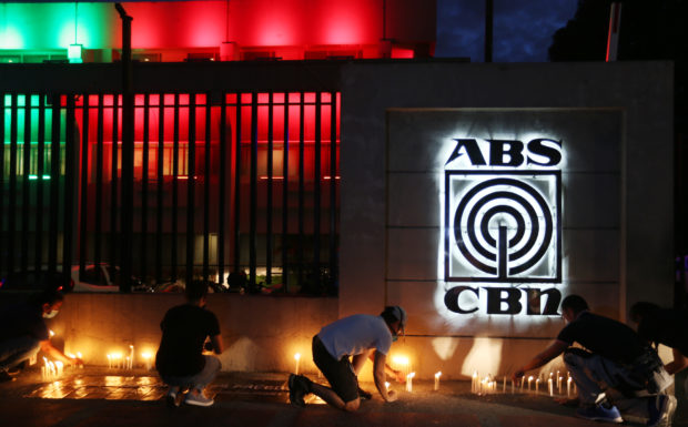 ‘KEEP US IN YOUR THOUGHTS’ ABS-CBN employees light candles in solidarity as the network’s darkest hour came on Tuesday night. —EDWIN BACASMAS
