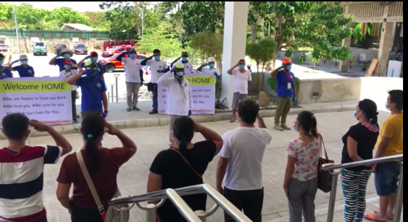 Personnel of the Disaster Risk Reduction Management Office of Lapu-Lapu City headed by Nagiel Bañacia salute the COVID survivors outside the ARC Hospital as they prepare to get transported back to their homes. | Nagiel Bañacia FB page