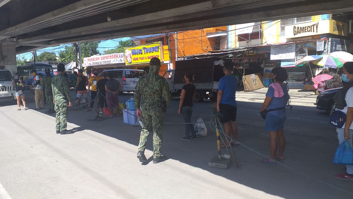 Talisay City Police are deployed in Tabunok Market this afternoon, June 22, 2020, to make sure that the public are still observing social distancing despite the city downgrading back to general community quarantine (GCQ). | Contributed Photo