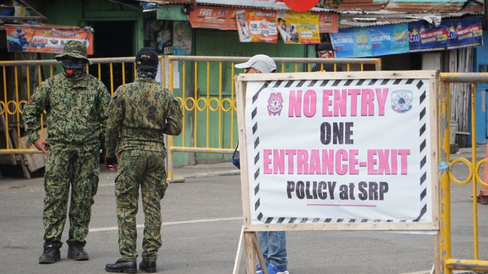 Policemen man the border control points at the South Coastal Road as Cebu province implements strict border controls between Cebu City on June 26. | Gerard Francisco