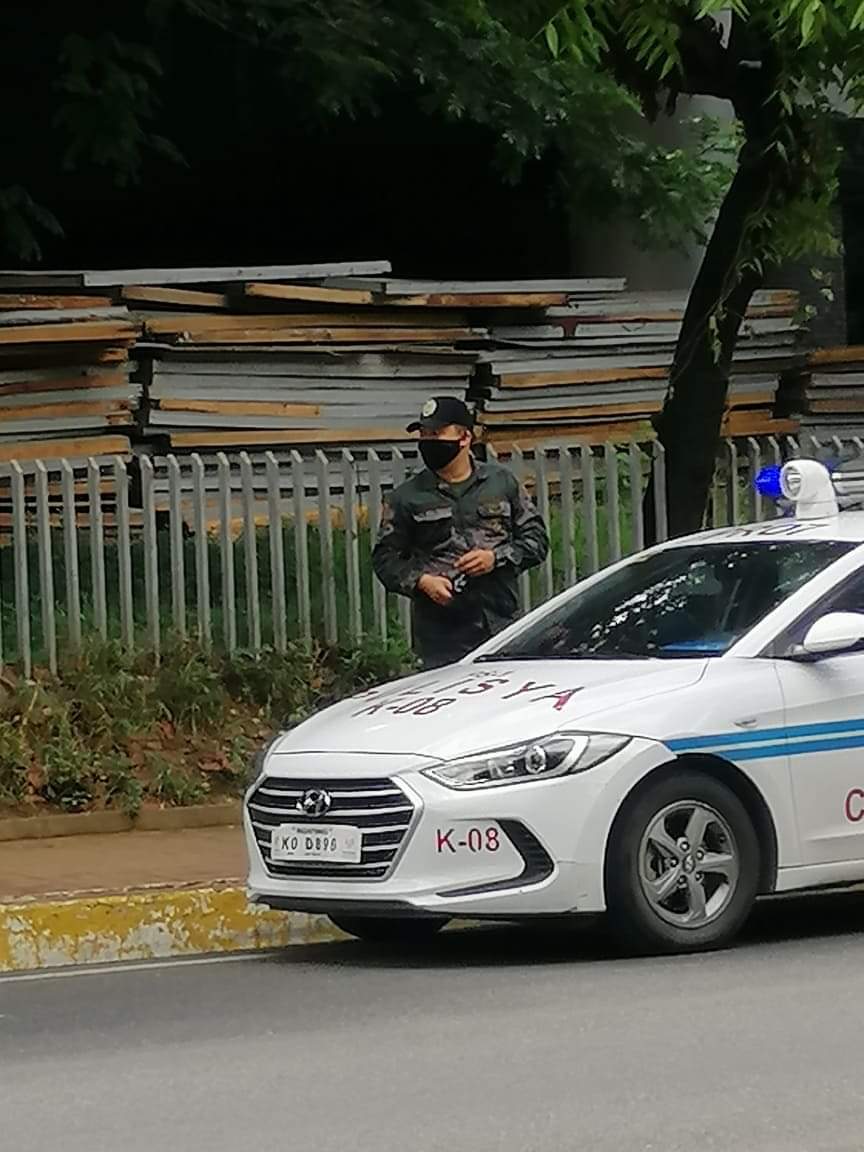 A uniformed police standing in front of UP Cebu when the Anti-Terror Bill rally was held on June 5, 2020. | Photo courtesy of Tug-ani