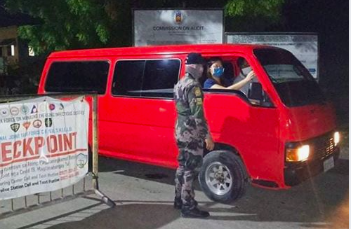 A policeman of the Cordova Police Station mans a checkpoint at the border of Cordova and Lapu-Lapu City in this June 11 photo. | Cordova Police Station FB page
