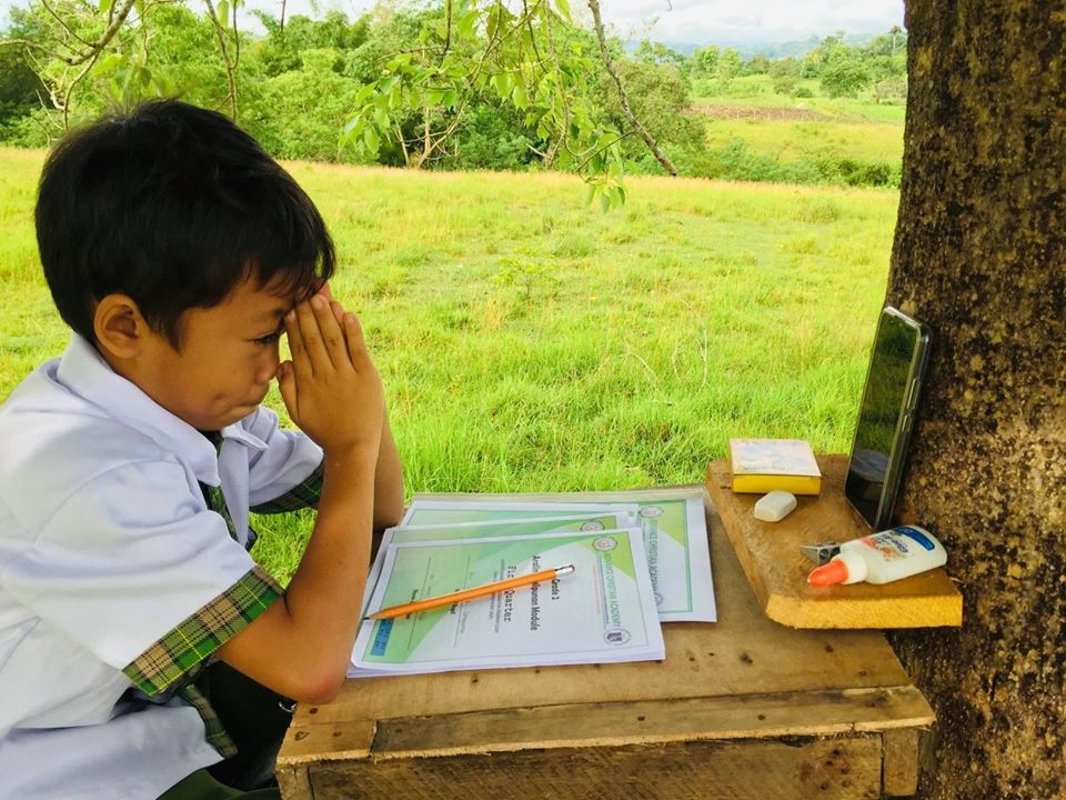 A grandson attends his online class sitting in a treehouse made by his grandfather in the middle of a ricefield where internet connection is strongest. |Contributed photo.