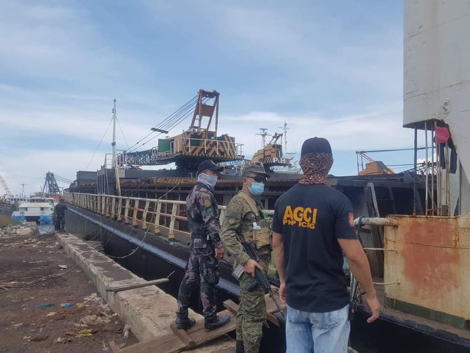 Consolacion policemen check a boat docked in a port in Barangay Tayud. | Photo courtesy of Consolacion police 