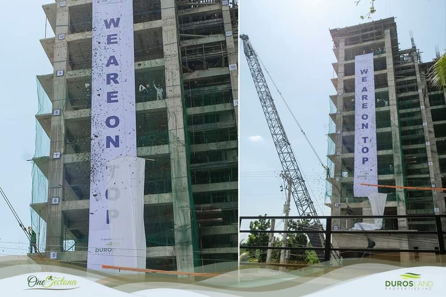 A photo of the One Tectona building with a banner and flying leaves as confetti