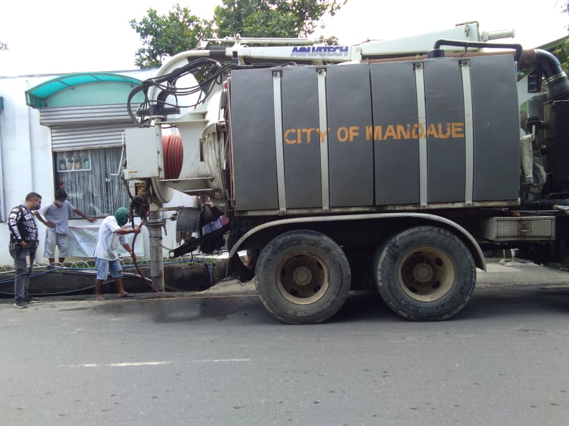 The Barangay Disaster Risk Reduction and Management Office of Alang-Alang in Mandaue City use a vacuum truck of the city's Department of General Services to clean Barangay Alang-Alang's canals to ease flooding in flood-prone areas of the barangay. CDN Digital | Mary Rose Sagarino