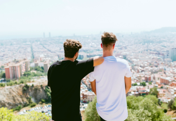 Two men looking at a city.
