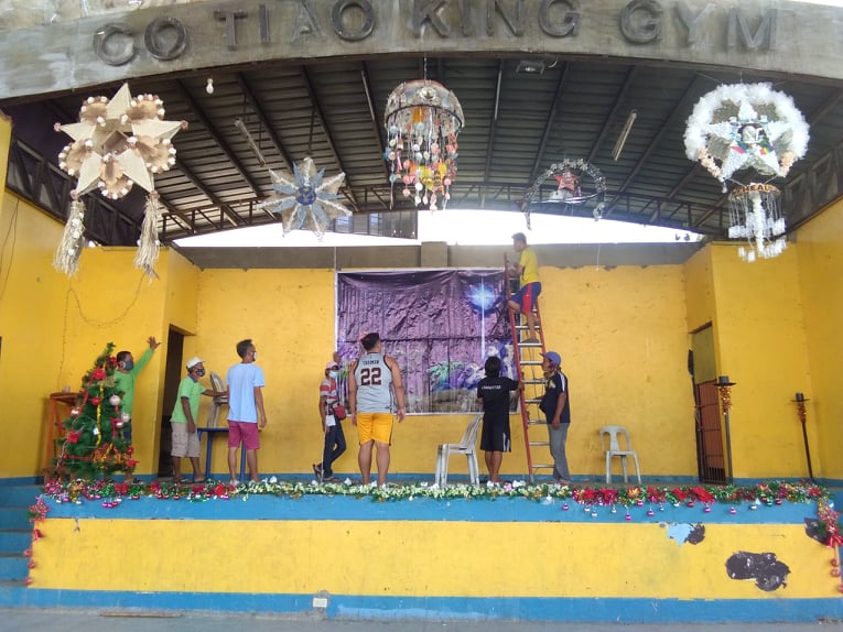 Barangay Tabok members prepare the stage of the gym for the Misa de Gallo. CDN Digital | Mary Rose Sagarino