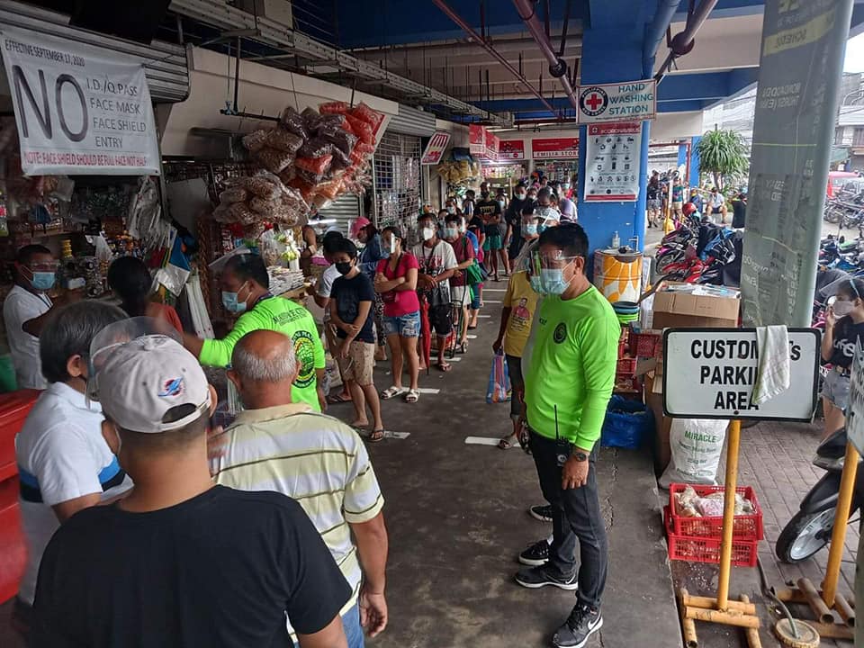 Members of the Mandaue City Legal Enforcement Unit (wearing green shirts) help enforce social distancing at the Mandaue City Public Market on December 31, 2020. The MCEU team will be back to clearing road obstructions on January 6. | MCEU FB page