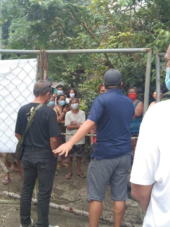 Personnel of the Cebu City Division on the Welfare of the Urban Poor assist the reopening of a subdivision gate to allow sitio residents landlocked behind the gates passage to the subdivision for at least six months. | Photo Courtesy of DWUP