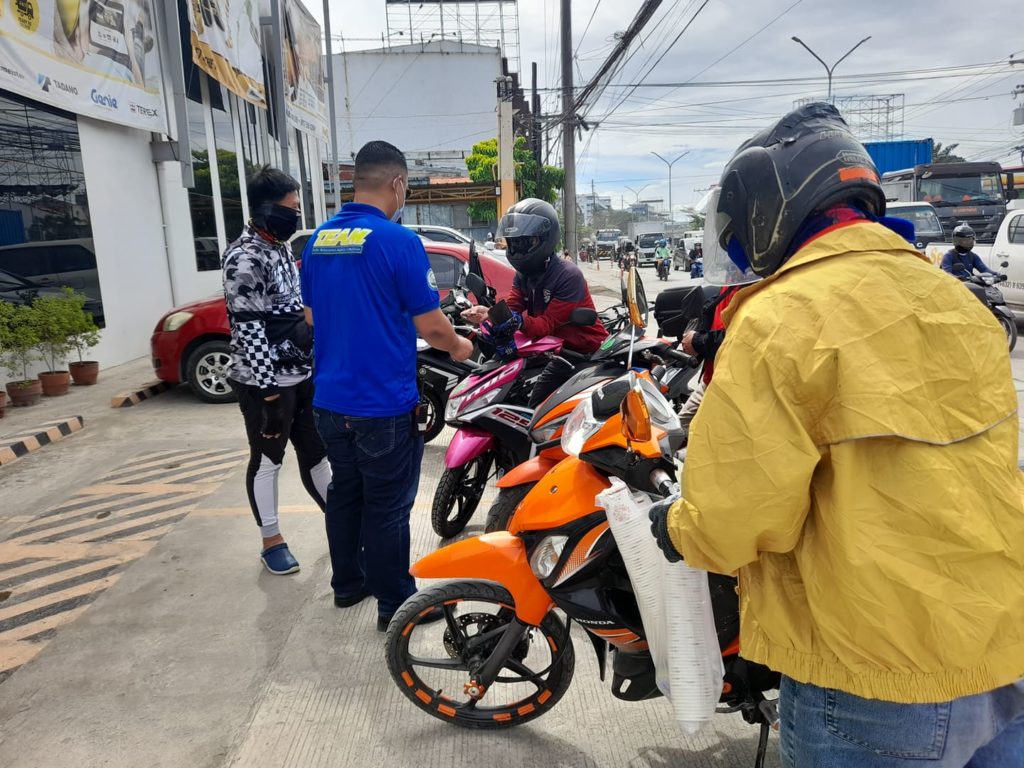 Lawyer John Eddu Ibañez, executive secretary of Mandaue City Mayor Jonas Cortes, apprehends three motorcycle riders caught encroaching on the city's bike lanes.