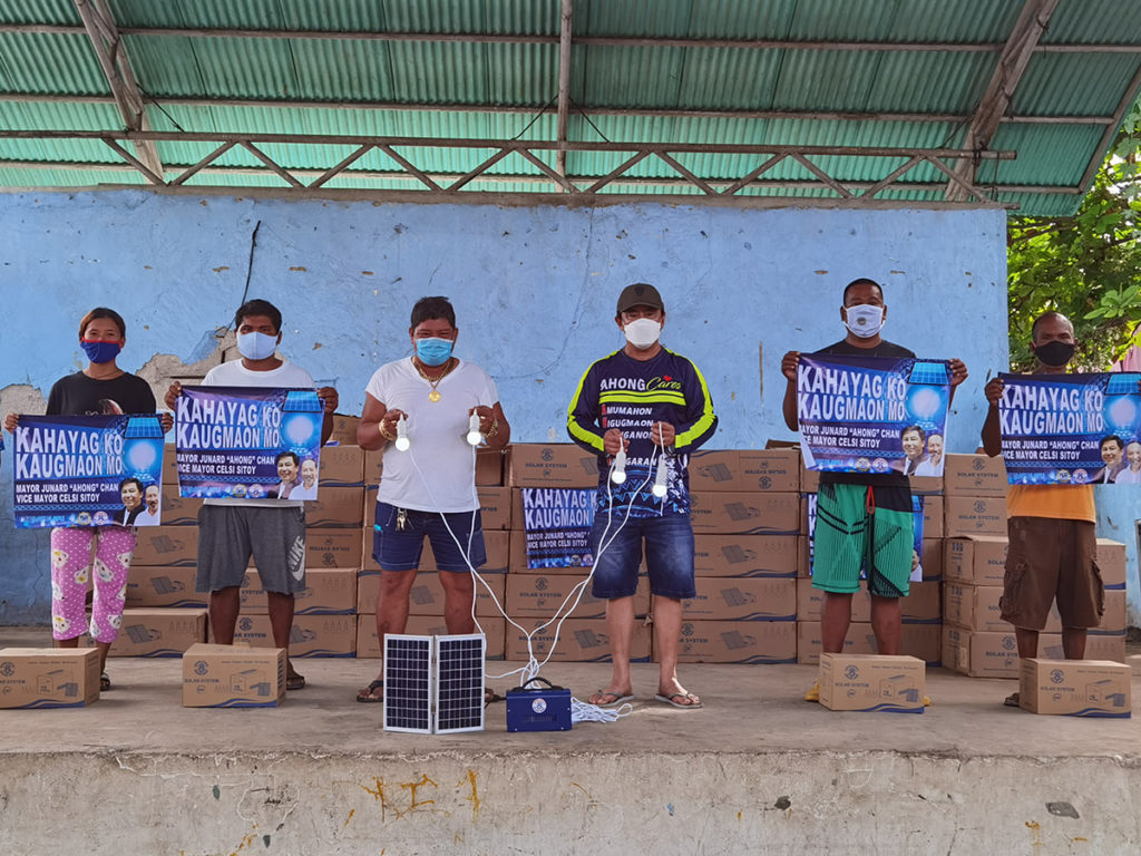 A family in Barangay Pangan-an, an islet barangay in Olango Island in Lapu-Lapu City, receives one of solar panel sets donated by the city government on Saturday, March 13. | Photo courtesy of Lapu-Lapu PIO