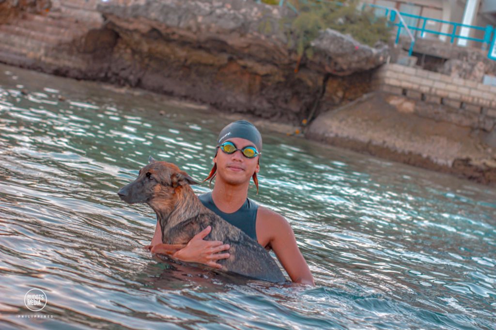 Oponganon, open water swimmer Cleevan Kayne Alegres, prepares to call it a day with his dog Sparta after one of his swims in preparation for his April 24, 40Km swim around Mactan Island. | Contributed photo