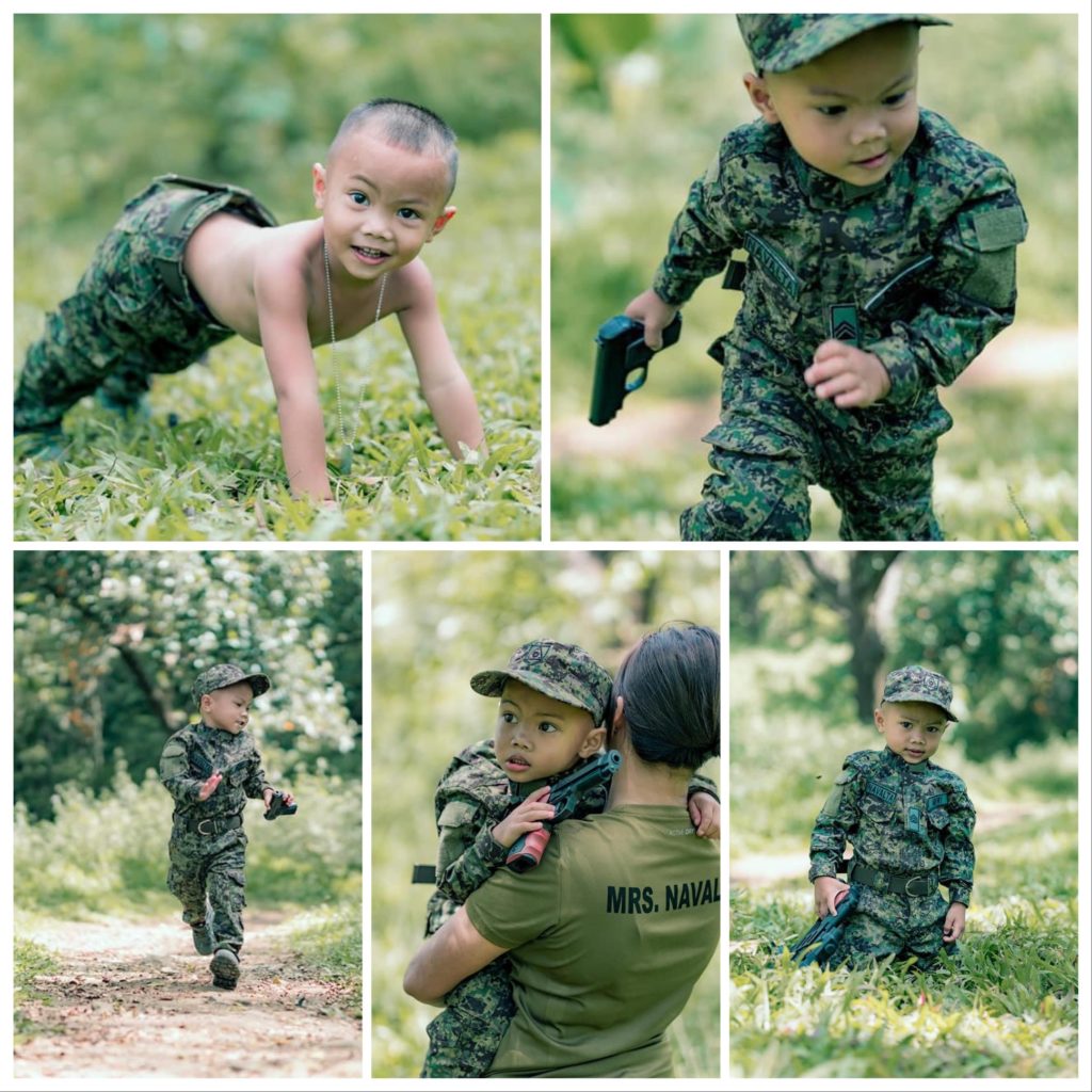 This is a collage of photos of 3-year-old boy, Yunjiero Navalta, whose father a soldier of the Philippine military, who died in an encounter in 2018. The first photo above left -- Yunjier does pushups, (from left clockwise),then the next the kid running with in Army uniform with a toy pistol, then the next the boy on his knees, then next photo, the kid in Army uniform is carried by his mother and the last photo is a long shot of Yunjiero in Army uniform running with a toy gun in his hand. 