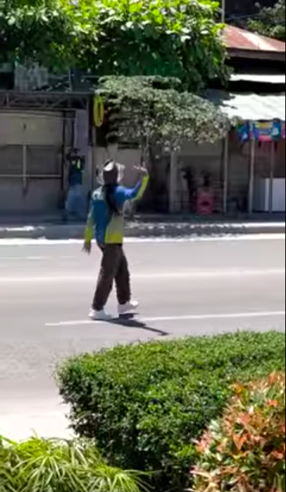 A traffic enforcer dances while manning traffic in a street in Consolacion town in northern Cebu. 