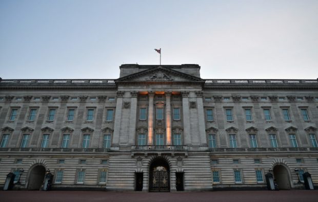 Buckingham Palace, the official residence of Britain's Queen Elizabeth II, is pictured in London at dusk on March 9, 2021. - Queen Elizabeth II is saddened by the challenges faced by her grandson Prince Harry and his wife Meghan, and takes their allegations of racism in the royal family seriously, Buckingham Palace said on March 9, 2021. "The whole family is saddened to learn the full extent of how challenging the last few years have been for Harry and Meghan. The issues raised, particularly that of race, are concerning," the palace said in a statement released on the queen's behalf. (Photo by JUSTIN TALLIS / AFP)