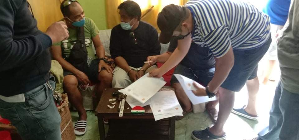 CONSOLACION ARREST: Benjie Gerundio is questioned by police after his arrest when a .357 revolver was found after a search inside his house was made by policemen. | Contributed photo