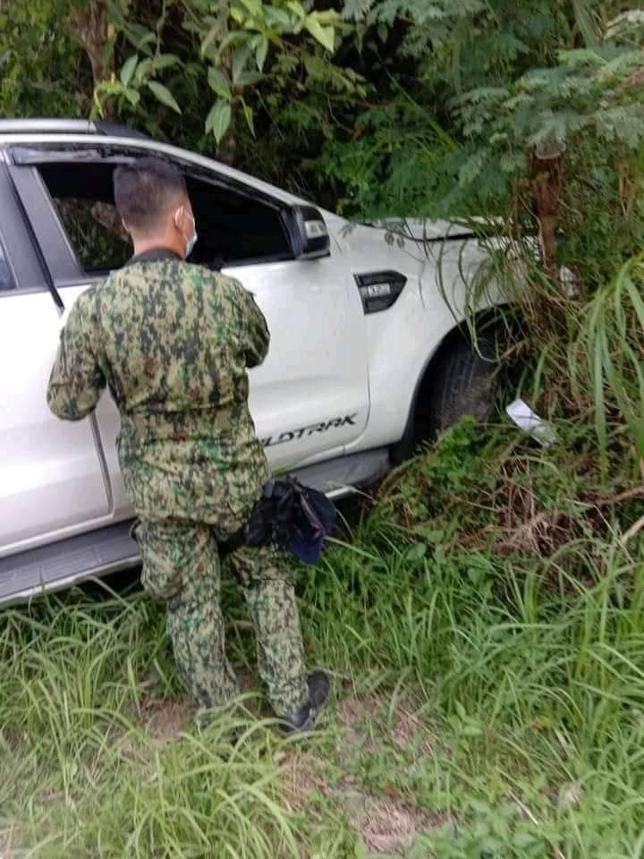 Balamban accident: A policeman checks on the pickup truck that collided with a motorcycle in Barangay Gaas, Balamban town, killing two people. | contributed photo