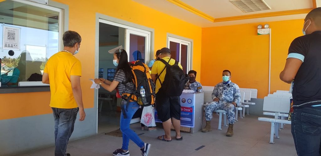 Passengers at the Sta. Fe port in Bantayan Island fulfill the requirements for them to travel to their destination.