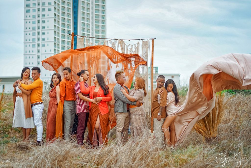Wedding planners sharing blessings to five couples. In this shot, the couples pose with their gowns and casual clothes for men.