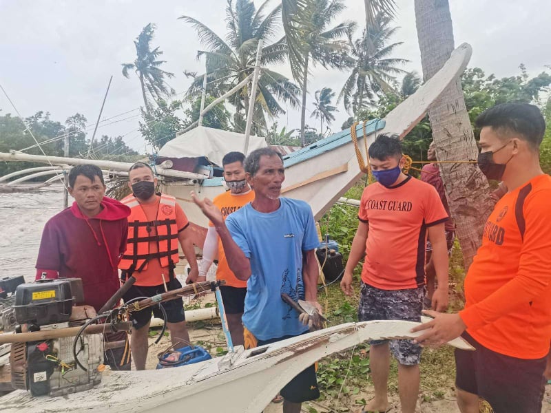 BISING AND RESCUE. Philippine Coast Guard personnel saved at past 2 p.m. two fishermen, whose boat became half submerged after it took in seawater due to the rough seas off the coast of San Remigio town in northern Cebu.