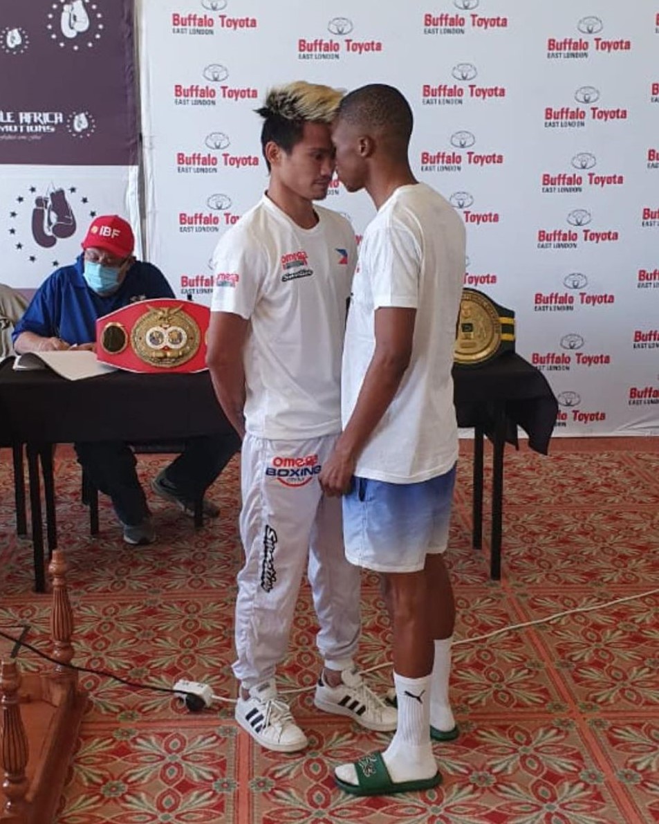 "THE BOMB" DURING WEIGH IN. Christian Araneta (left) butts heads with his opponent, Sevinathi Nontshinga after they both passed the official weigh-in for their world title eliminator bout tomorrow, April 25, in South Africa. | Photo from Julius Erving Junco via Glendale Rosal