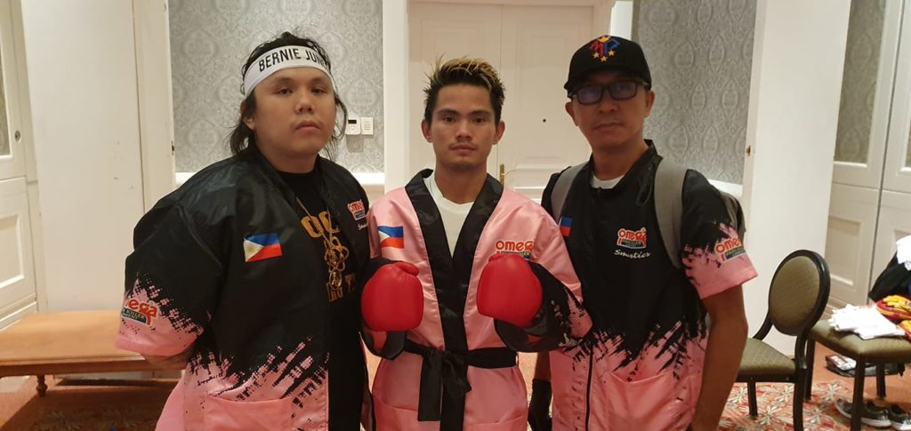Cebu's "The Bomb" loses. Christian "The Bomb" Araneta (middle) along with trainer Julius Erving Junco (left) and Omega Pro Sports International (OPSI) Vice President Jerome Calatrava take a pose for the camera before Araneta's bout in South Africa this morning, April 25. | Photo from Omega Boxing Gym Facebook page