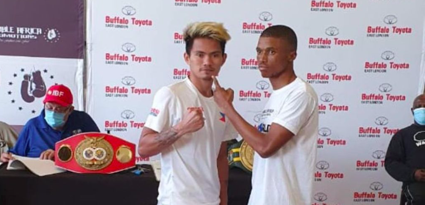 Christian Araneta (left) poses with his opponent, Sevinathi Nontshinga after they both passed the official weigh-in for their world title eliminator bout tomorrow, April 25, in South Africa. | Photo from Julius Erving Junco via Glendale Rosal