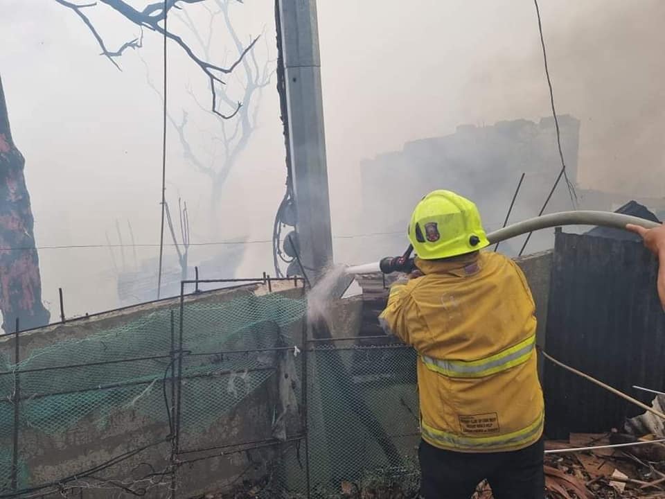 Electrical overload. Fire investigators are checking if an electrical overload caused last April 18's fire in Barangay Tabok, Mandaue City. In photo is a firefighter training his water hose to a house razed by the Sunday morning fire in Upper Tabok, Barangay Tabok in Mandaue City. | Photo courtesy of Mandaue CDRRMO