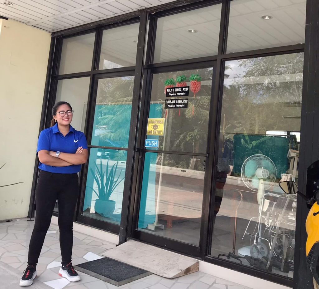 Physical therapist, Florie Jane Vergara Dimol proudly poses at the front of her clinic, the Physical Therapy Experts- Dumanjug Cebu & Hinunangan So. Leyte. | Contributed Photo