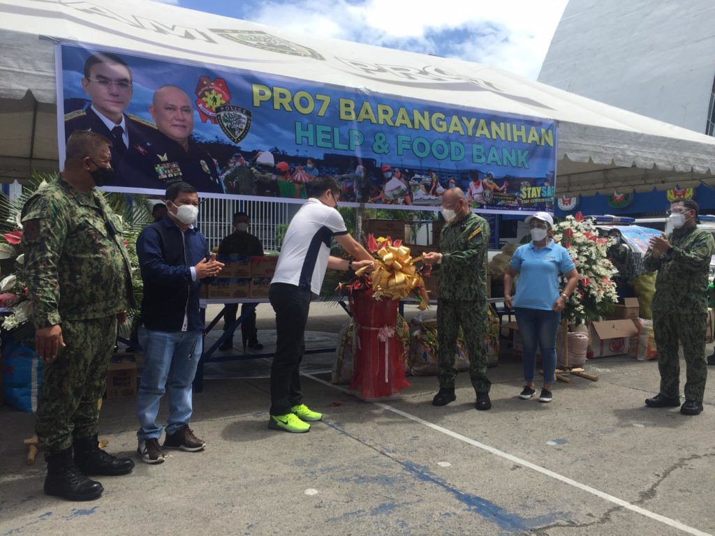 PRO-7 chief leads activities. Police Brigadier General Ronnie S. Montejo, PRO-7 director, leads the cutting of ribbon for the launching of the food bank and help project of the Barangayanihan program of the PNP.| Photo by Pegeen Maisie Sararana